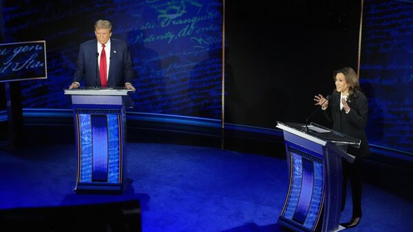 Republican presidential nominee former President Donald Trump watches as Democratic presidential nominee Vice President Kamala Harris speaks during an ABC News presidential debate at the National Constitution Center, Tuesday, Sept. 10, 2024, in Philadelphia.  - Sputnik Türkiye