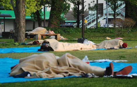 ビニールシートの上で毛布にくるまって一晩を過ごした人たち＝熊本市中央区の白川公園で２０１６年４月１５日午前６時２０分、中里顕撮影