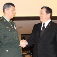 日中防衛相会談で握手する浜田靖一防衛相（右）と中国の李尚福国防相＝シンガポールで2023年6月3日、源馬のぞみ撮影