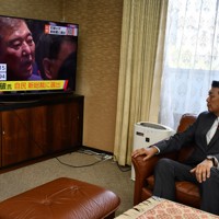 自民党総裁選で石破茂氏が新総裁に選出されたことを伝えるテレビ画面を見つめる同党福岡県連の原口剣生会長＝福岡市博多区で2024年9月27日午後3時24分、城島勇人撮影