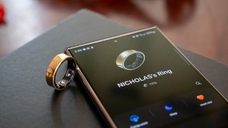 The gold Samsung Galaxy Ring alongside the Samsung Wearables app