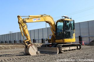 An autonomously operated backhoe, like this one used in a JAXA test, could someday help construct a moon base.