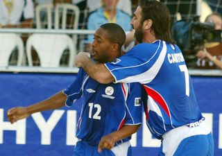 Eric Cantona and Anthony Mendy celebrate a goal for France at the 2005 Beach Soccer World Cup in Rio de Janeiro in May 2005.