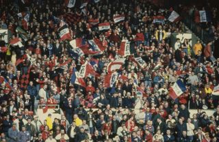 Manchester United fans wave flags with the words "Eric the King" in tribute to Eric Cantona in a Champions League game against Borussia Dortmund in April 1997.