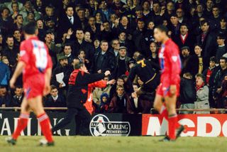 Eric Cantona's infamous kung fu kick on an abusive Crystal Palace fan during the Premier League match between Crystal Palace and Manchester United at Selhurst Park in November 1995.