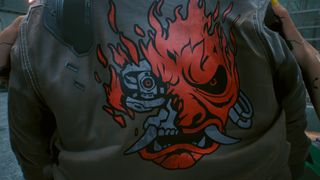 A close-up of the cybernetic oni design on the back of Johnny Silverhand's samurai jacket in Cyberpunk 2077.