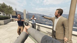 GTA 5 cheats - four men point guns at each other in a standoff