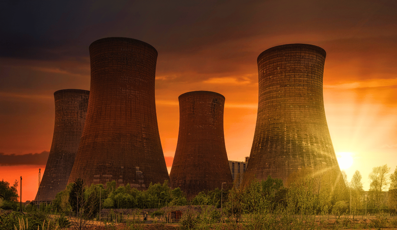 Nuclear power plant backlit by sunset