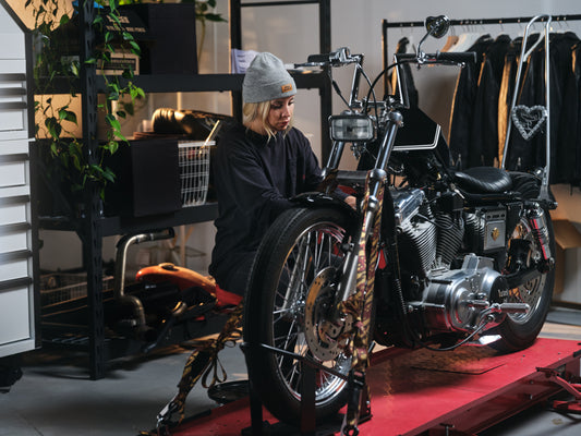 Person working on a motorcycle from "Hell Babes"