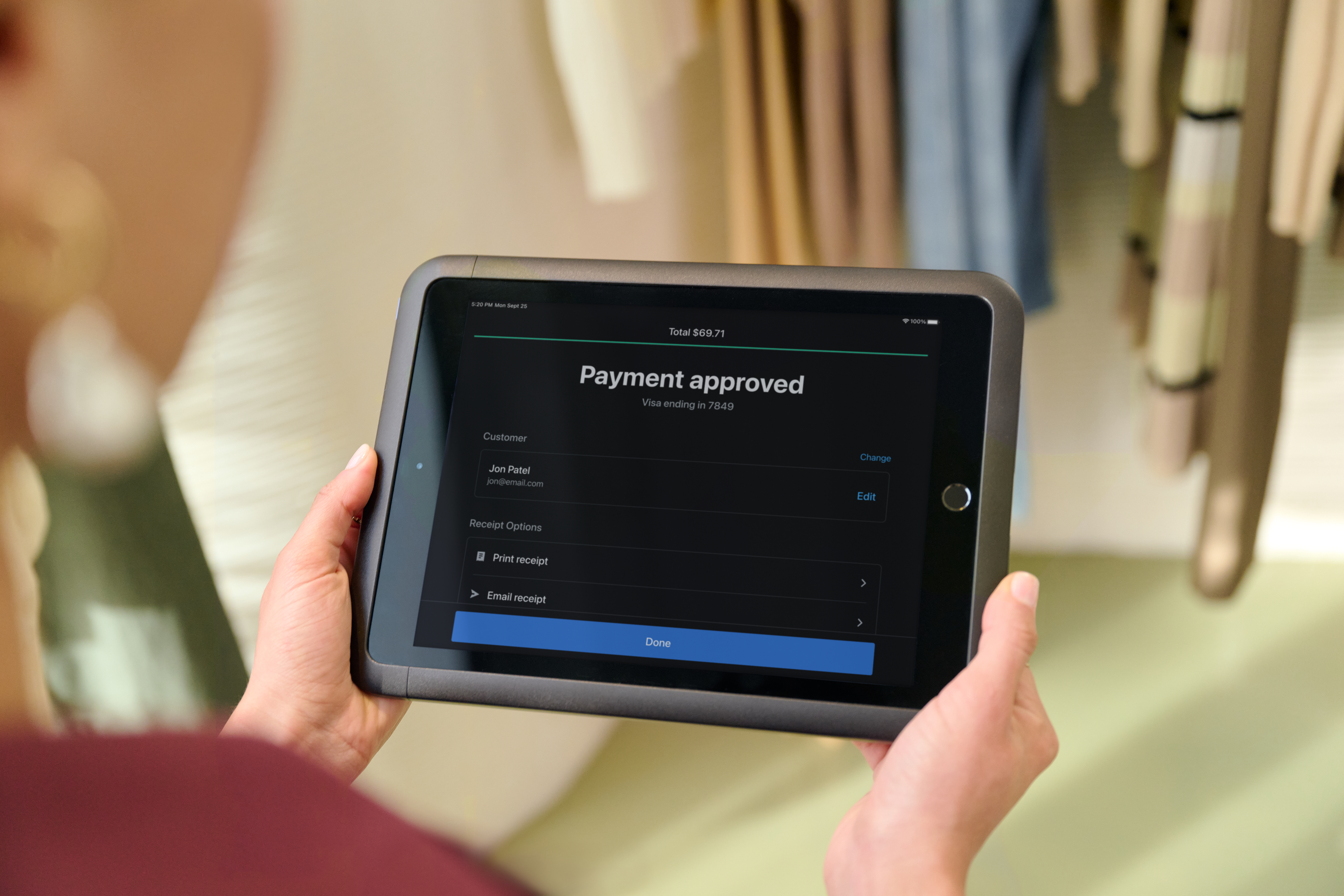 A customer taps their card on POS Terminal at the counter.