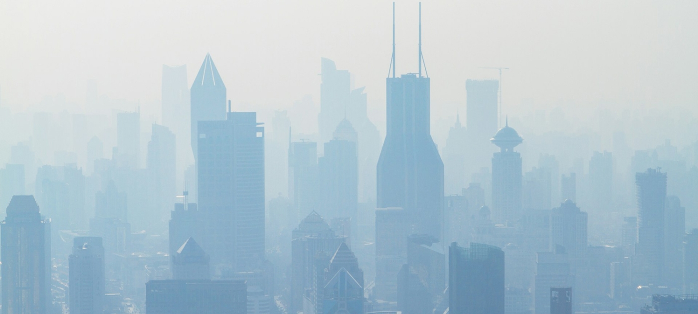 A landscape view of polluted air hanging over a city.