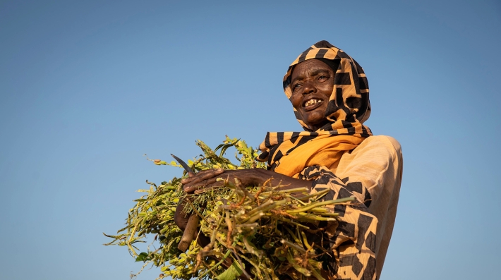 A woman holding crops