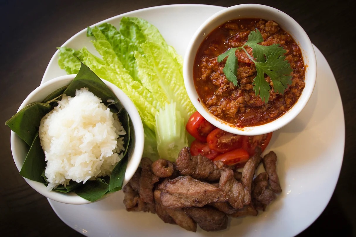 Nam prik, meat, rice, and lettuce wraps.