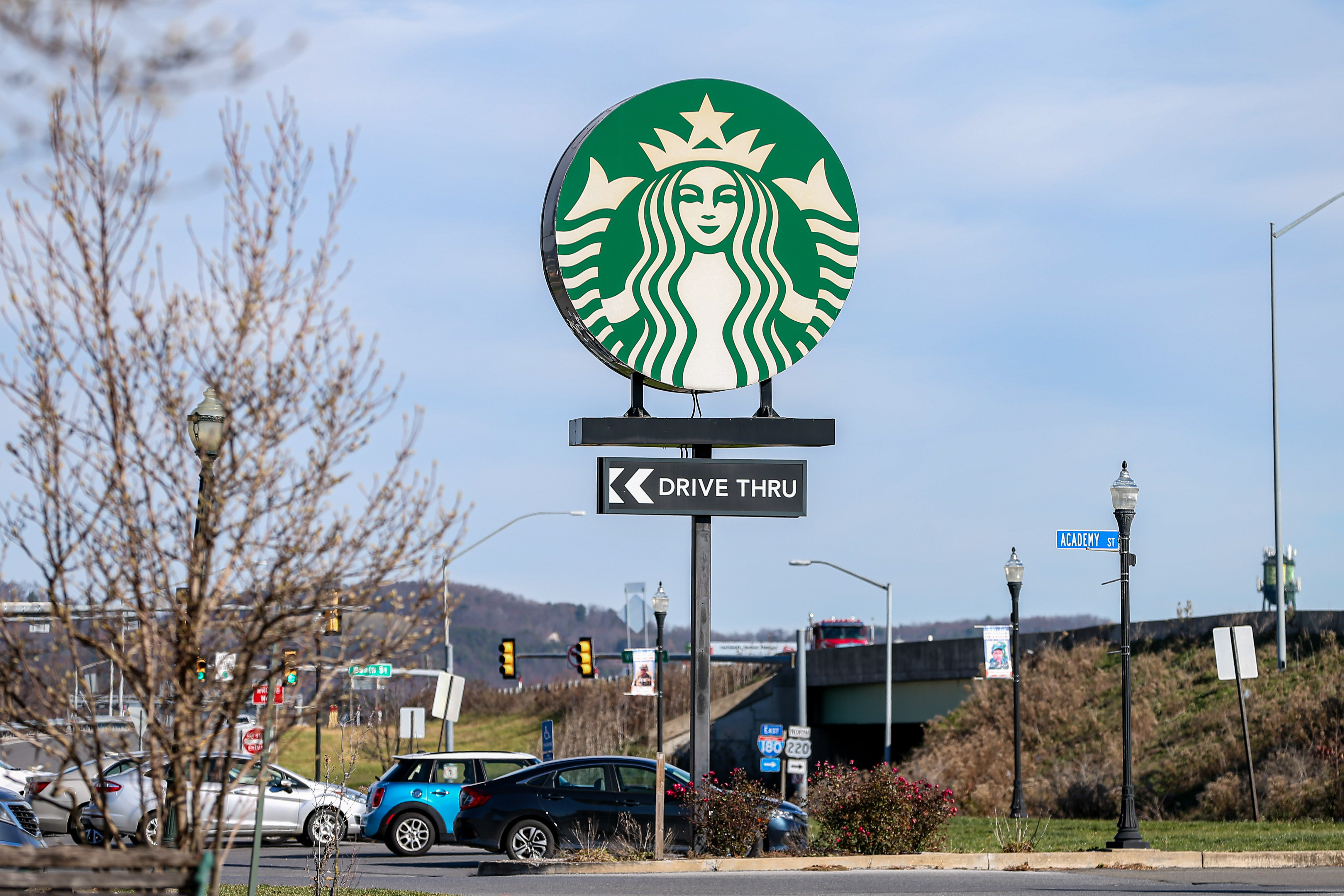 A large sign with the Starbucks logo is seen at its...