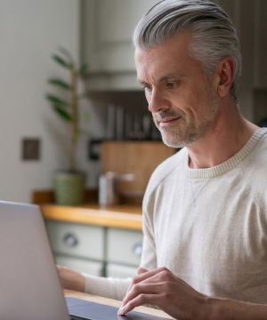 Man examining work on a laptop