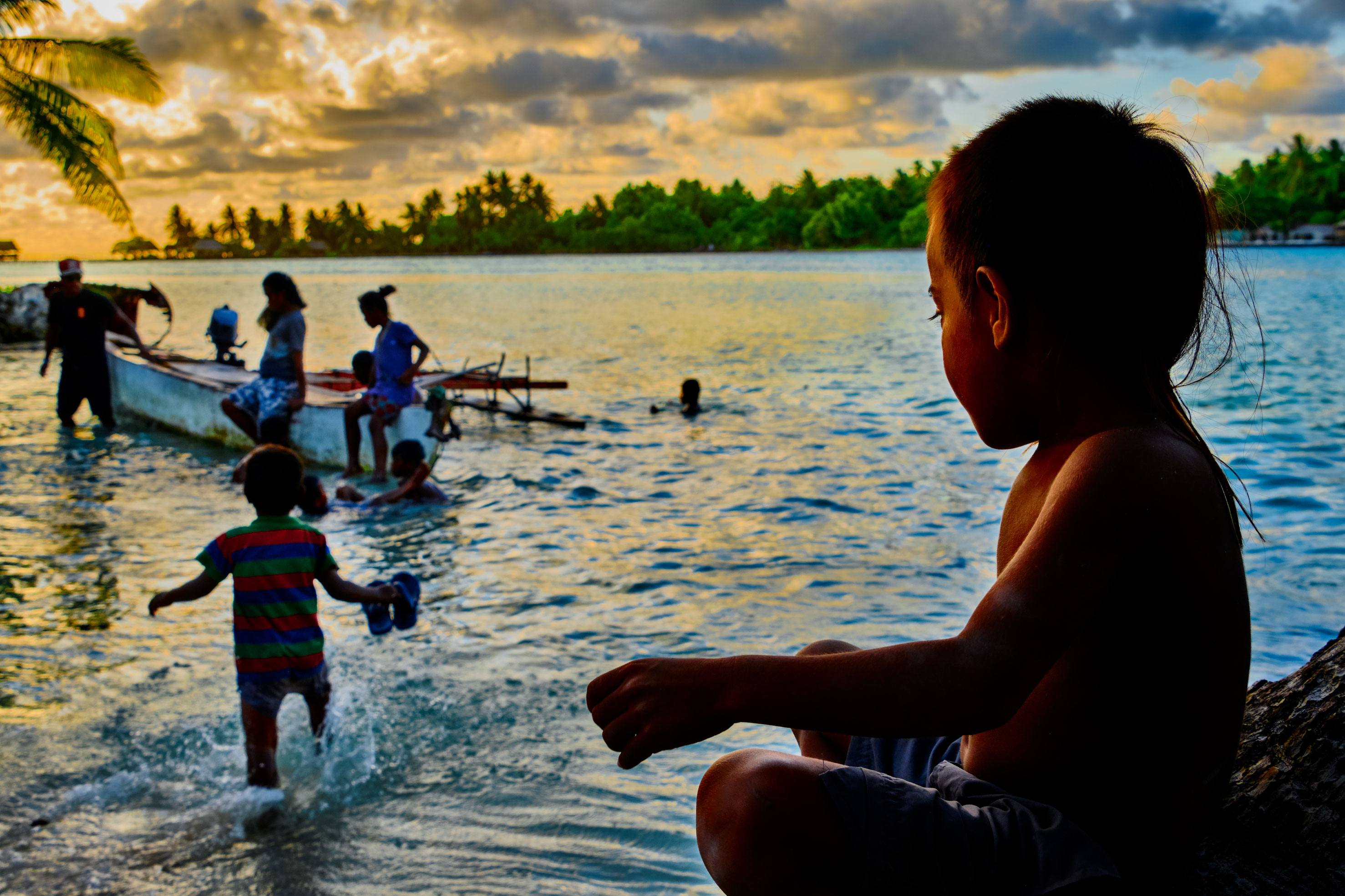 Child looking at people in water