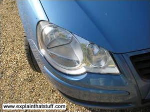 A close-up of a car headlamp showing the lenses inside