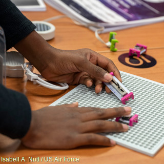 Child's hands carrying out a STEM electronics activity in fifth grade.