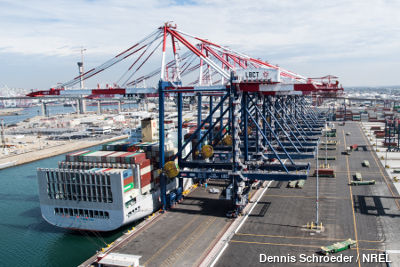 A row of port cranes unloading a container ship in Long Beach, California. Photo by Dennis Schroeder, NREL