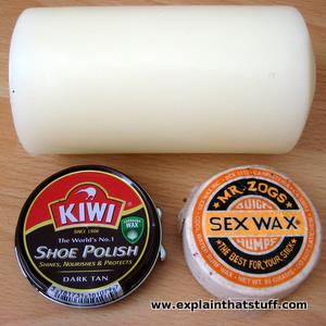 Three common types of wax: a beeswax candle, a carnauba wax shoe polish tin, and surf wax made from paraffin and beeswax.