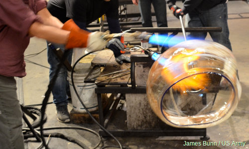 Blowing and spinning a piece of glass artwork