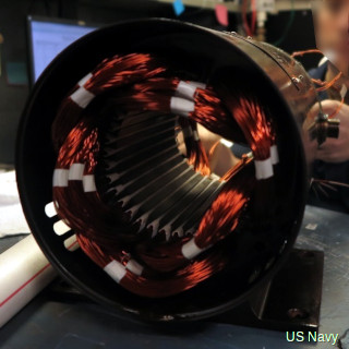 A typical AC induction motor with its case and rotor removed, showing the copper windings inside.