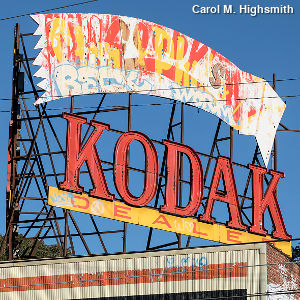 Old vandalized Kodak dealer sign.