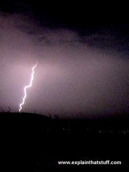 Lightning bolt striking down through a night sky