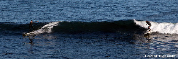 Two surfers surfing either end of a peeling wave. Photo by Carol M. Highsmith, Library of Congress