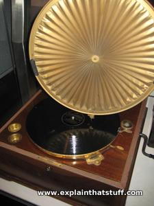 A windup phonograph with needle on a 78 record and Sterling Primax sound amplifying horn