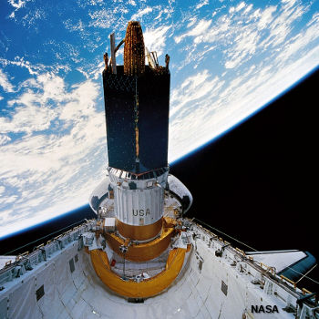 The Space Shuttle launching a communications satellite from its payload bay.