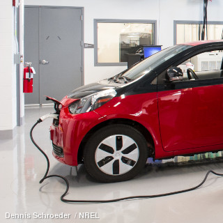 Red electric car charging up in a smart home