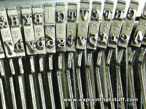 Type hammers in a typewriter showing metal letters in relief