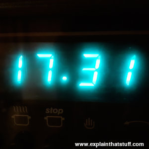 Green vacuum fluorescent display showing the time on a stove.