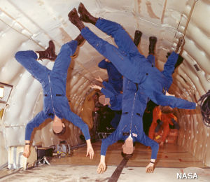 NASA astronauts practice floating in weightlessness in the KC-135 vomit comet simulator airplane.
