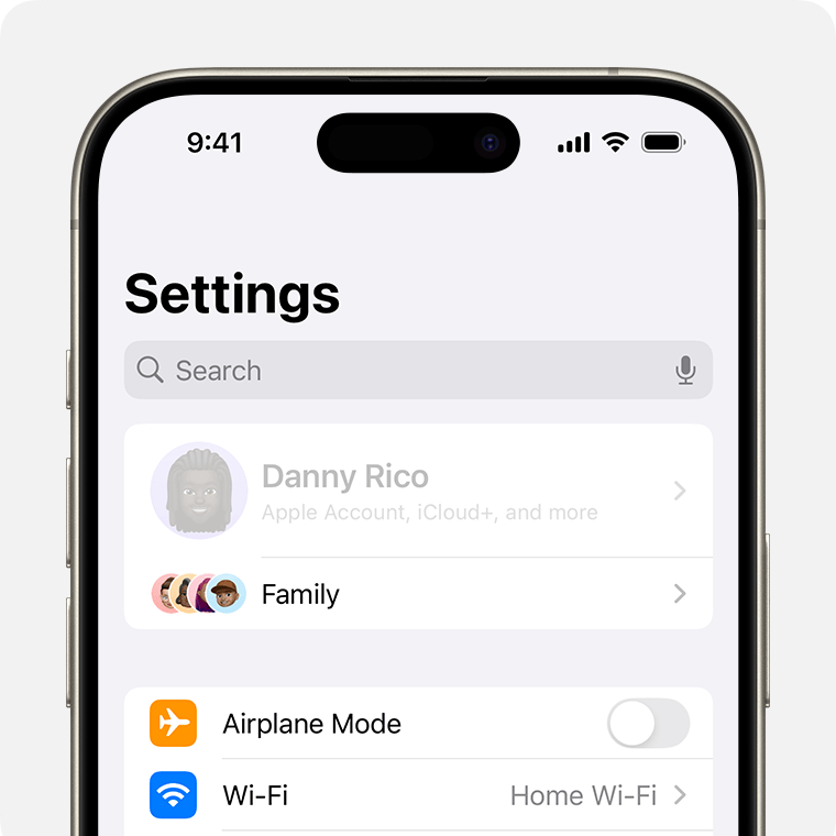 An iPhone showing the owner's name grayed out at the top of Settings.