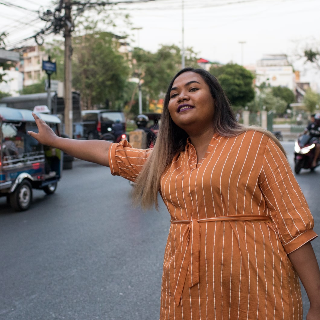 A traveler hailing a cab in a sunny destination