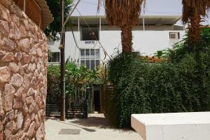 a house with a gate in front of a building at אדום 179, דירות נופש in Eilat