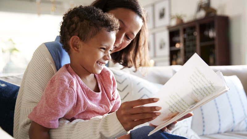 Mother and son reading on the couch