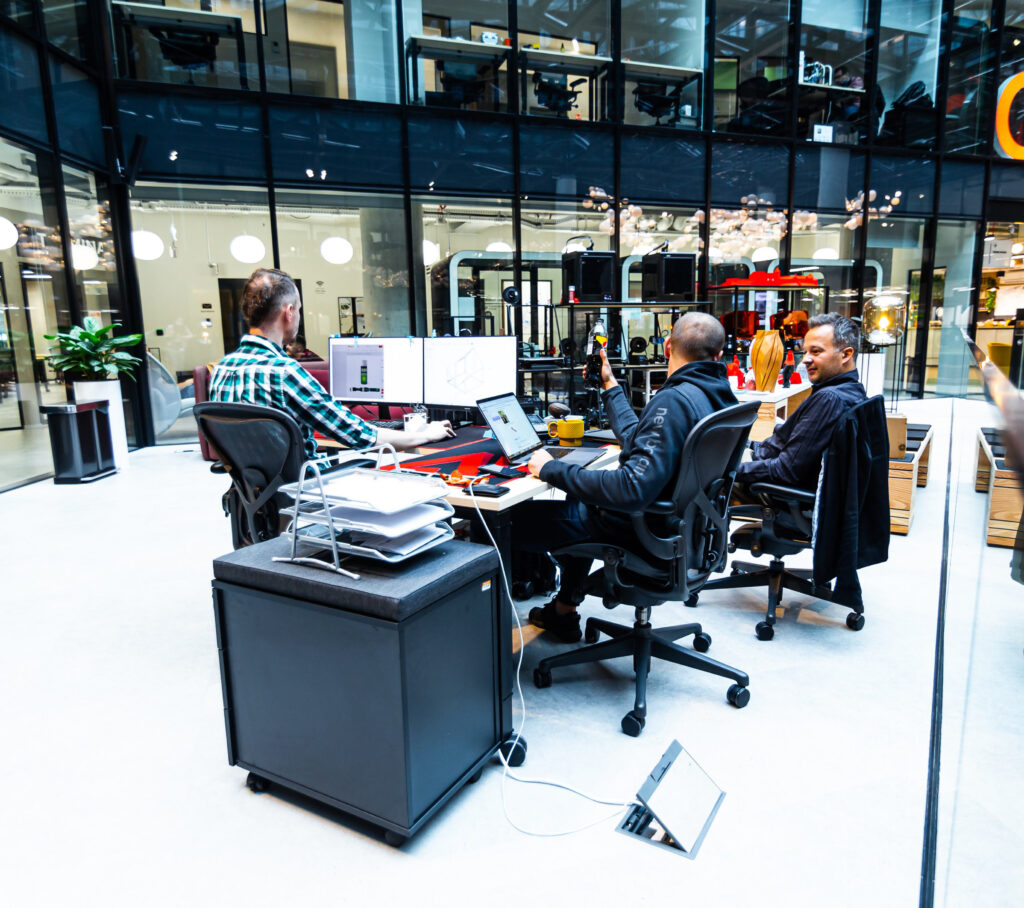 Photo of three people working in shared space at CIC Warsaw