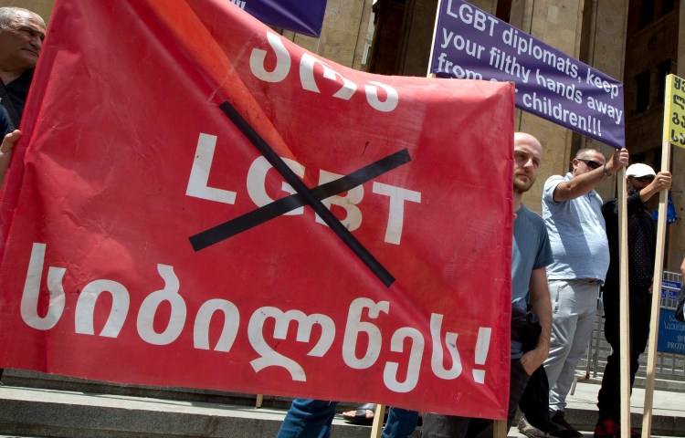 Georgian far right parties and their supporters hold a banner that reads, "No to LGBT darkness," in front of parliament during a rally against Pride Week in Tbilisi, Georgia, in 2022.