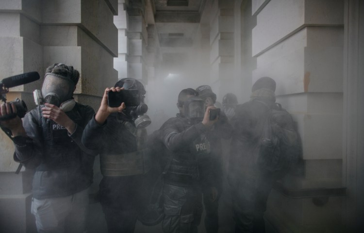 Journalists report from the U.S. Capitol as pro-Trump protesters stormed the building on January 6, 2021, to contest the certification of the 2020 presidential election. (Photo: Reuters/Ahmed Gaber)