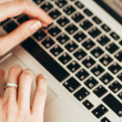 A person sitting with a laptop