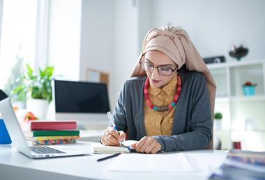 Female primary school teacher works at her desk