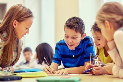 Group of students talking and writing at school