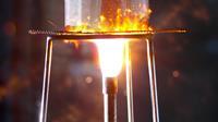 A Busen burner heating a reaction on a wire gauze and tripod