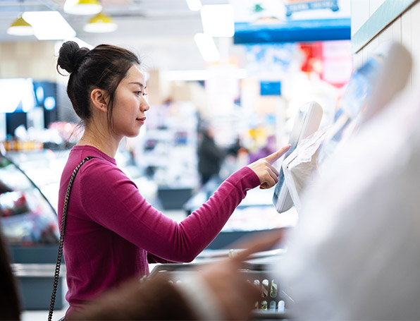 Woman at self checkout