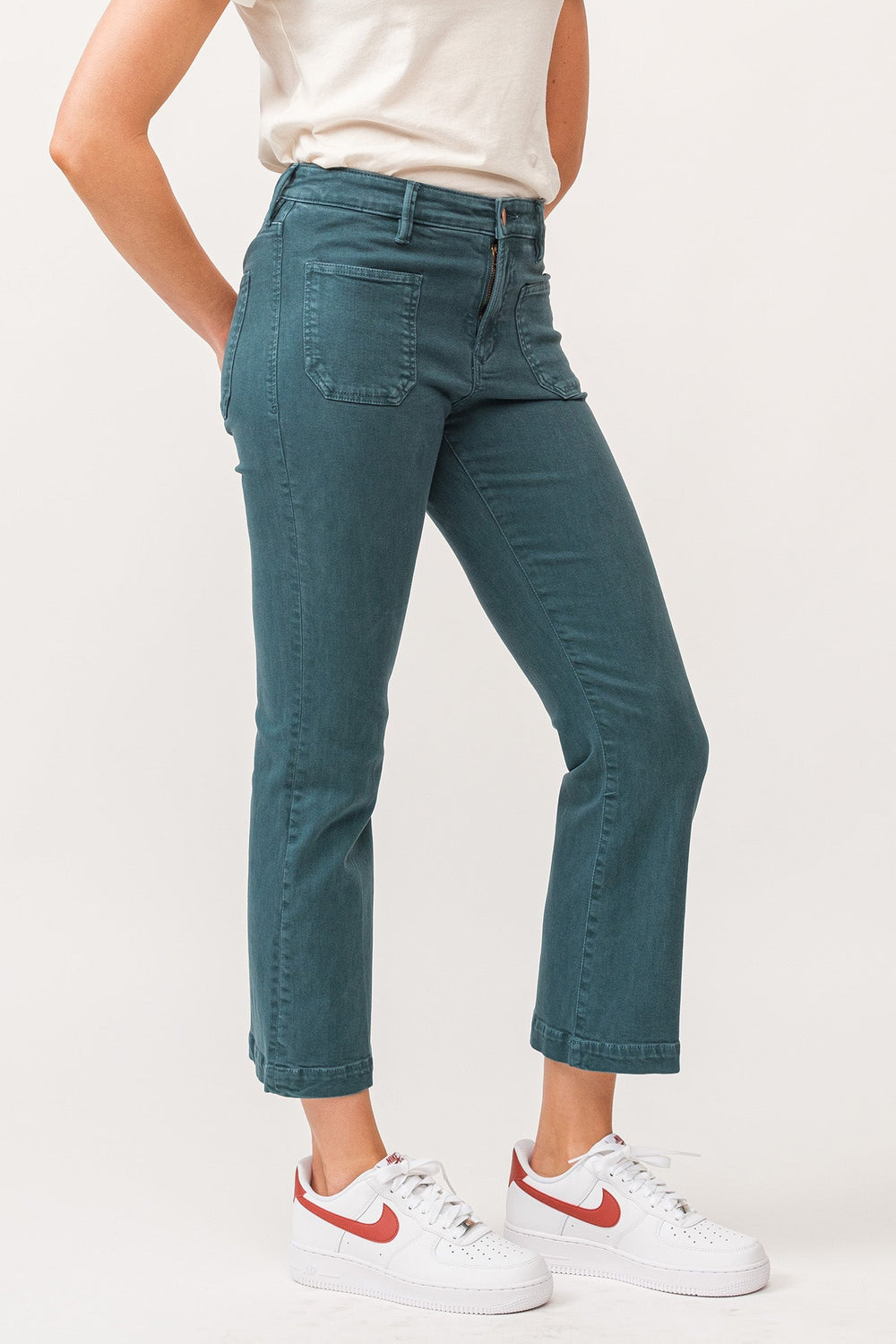 image of a female model wearing a JEANNE MID RISE CLEAN HEM CROPPED FLARE JEANS DEEP TEAL DEAR JOHN DENIM 