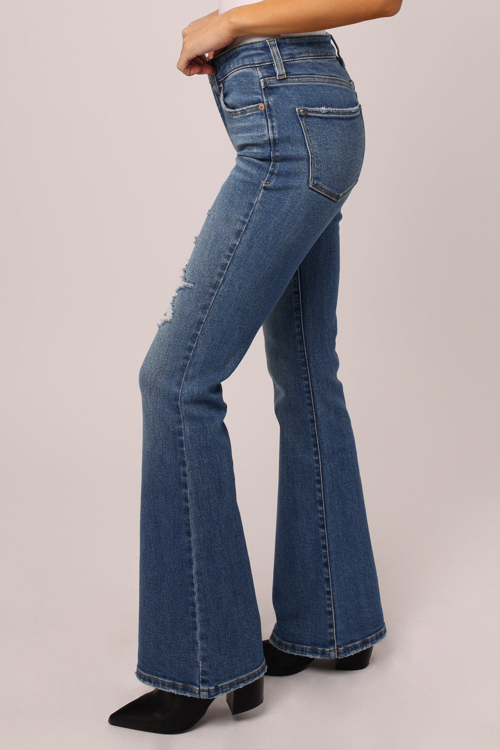 image of a female model wearing a ROSA HIGH RISE FLARE JEANS PATAGONIA DEAR JOHN DENIM 