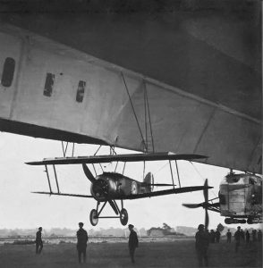 sopwith camel strung up under an airship